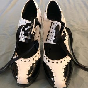 Black and white brass knuckle heels